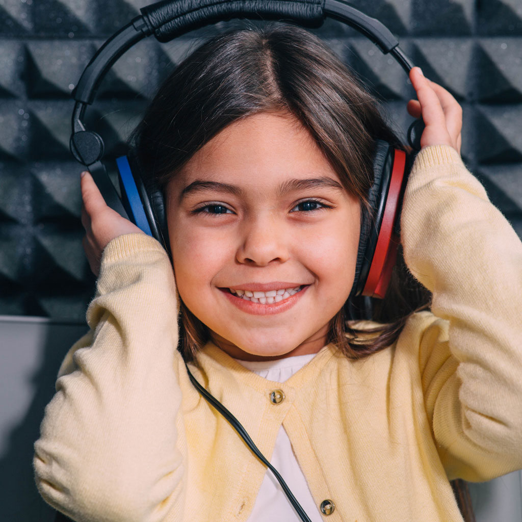 network hearing child smiling with hearing test headphones